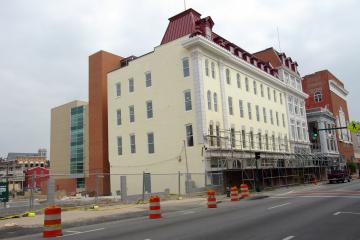 construction cones next to brick building