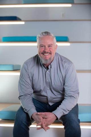 Man in blue shirt sitting on steps