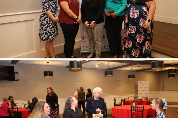 scholarship winners, 5 women, posing in front of a USMH sign